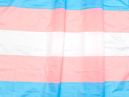 Transgender fabric flag with white, pink, blue strips. Close-up transgender pride flag as background or textureの写真素材