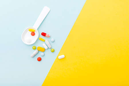 Medical composition with color pills, drugs, top view. Set of capsules, drugs. Space for text.