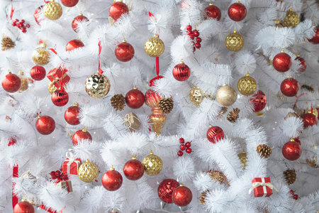 White or silver Christmas tree with red, gold toys, New Year compositionの写真素材