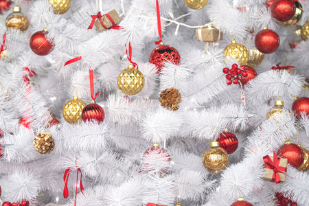 White or silver Christmas tree with red, gold toys, New Year compositionの写真素材