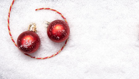 Red Christmas balls, Christmas tree decorations on snow, layout, space for textの写真素材