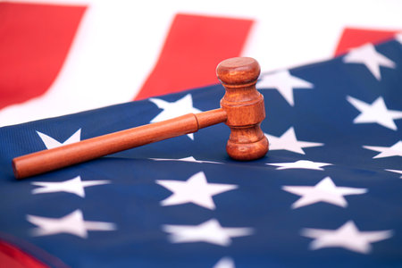Wooden judge gavel on USA flag, conceptual image about courtの写真素材