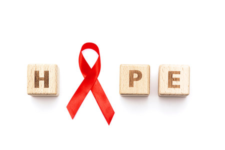 Word HOPE and red ribbon isolated on whiteの写真素材