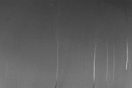Real glass Window with steam and condensation on surface raining Nightの写真素材