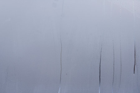 Window with condensate or steam after heavy rain, large texture or backgroundの写真素材