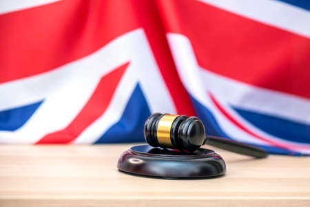 UK flag and judges wooden gavel at the courthouse, concept pictureの写真素材