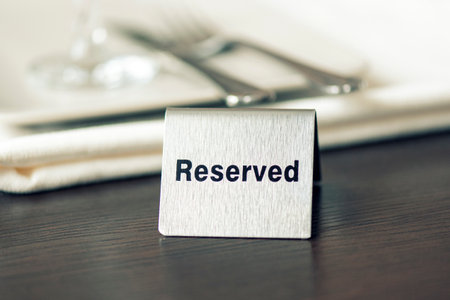 Reserved sign, iron plate on the table at cafe or restaurant, toned pictureの写真素材