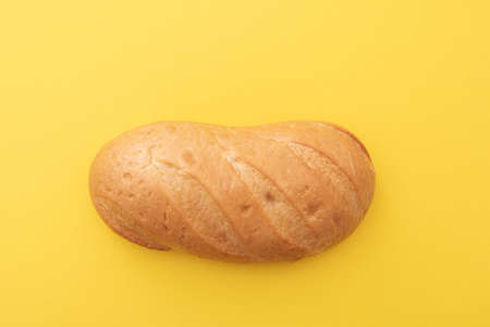Loaf, white bread, baton on yellow surface, top view, lay out, space for textの写真素材