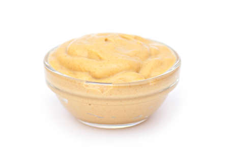 Mustard sauce in small glass bowl, isolated in white. Mustard sauce as dressingの写真素材