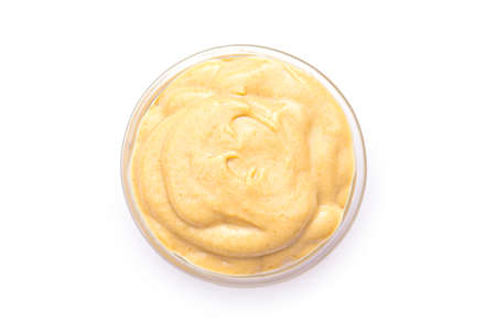 Mustard sauce in small glass bowl, isolated in white. Mustard sauce as dressingの写真素材