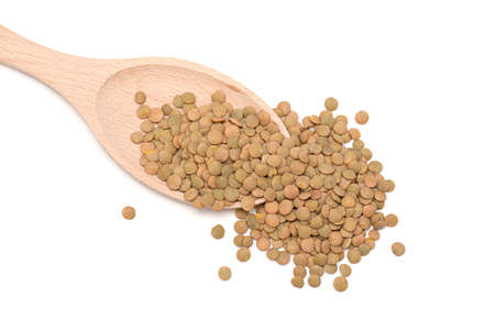 Green Lentil on wooden spoon isolated on white, top viewの写真素材