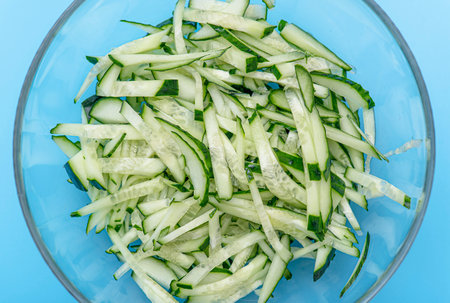 Chopped Cucumber Slices in glass Bowl for green Saladの写真素材