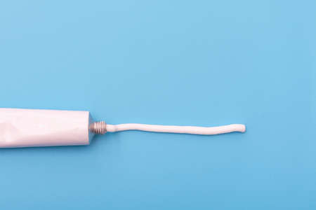 Tube with white cream or ointment blue backgroundの写真素材