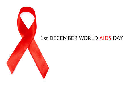 World AIDS Day inscription on white background and Red ribbon as the global symbol for solidarity with HIV people and those living with AIDSの写真素材