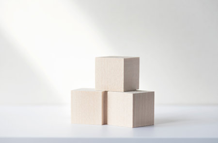 Three wooden square blocks or cubes on white desk. Mockup, space for text. Concept business pictureの写真素材