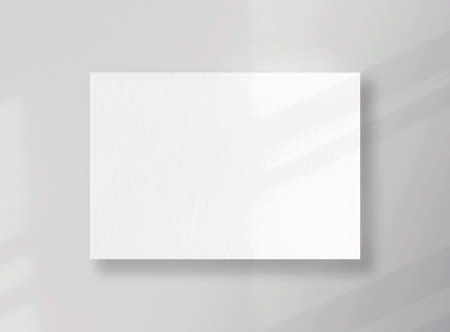 Blank square card, sheet as mockup with sunny shadows on gray surfaceの写真素材