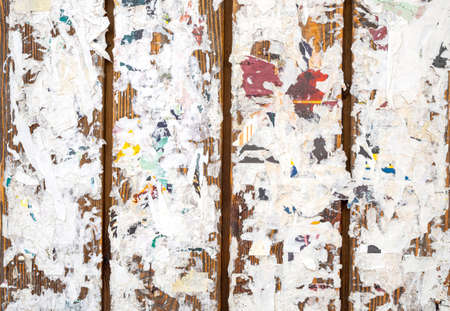 Colorful torn posters on grunge old walls as background or textureの写真素材