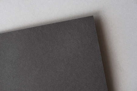 Black sheet on the top of gray. Two blank dark cadboard sheets as mock up with space for text, top viewの写真素材