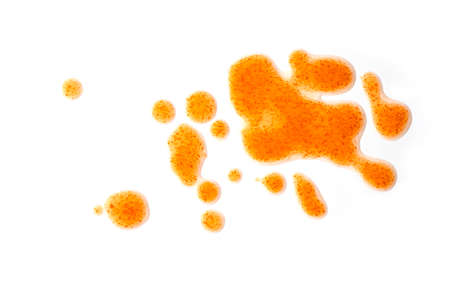 Red drops of chili sauce, close-up spots, splashes isolated on white background, top view