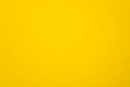 Blank yellow paper, rough yellow sheet as texture or background, bright, warm cardboard, top view, space for textの写真素材