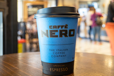 LONDON - OCT 21: Cafe Nero interior. Paper cup with Nero logotype on a table. October 21.2021 in UK. Nero is a British coffeehouse company headquartered in London.のeditorial素材