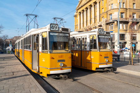 BUDAPEST - JAN 20: Two traditional yellow tramways in a street of Budapest, January 20. 2022 in Hungaryのeditorial素材