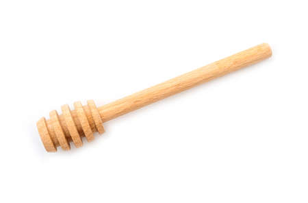 Honey dipper spoon isolated on whiteの写真素材