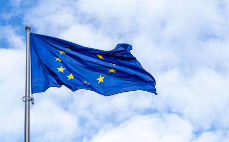 Panoramic view of a waving EU flag or European Union flag against blue skyの写真素材