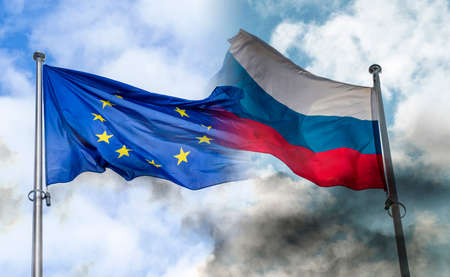 Russian and EU flags covered by black smoke, concept picture about sanctions and conflictsの写真素材