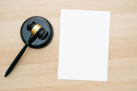 Workplace of judge with gavel and blank white clean sheet as mockup, space for textの写真素材