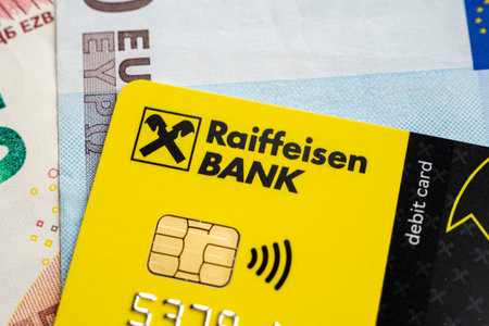 BERLIN - MAR 25: Logotype of the Raiffeisen bank on a plastic card, top view, in Berlin, March 25. 2022 in Germany.のeditorial素材