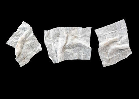 Set with three used crumpled wet wipes or napkins isolated on blackの写真素材