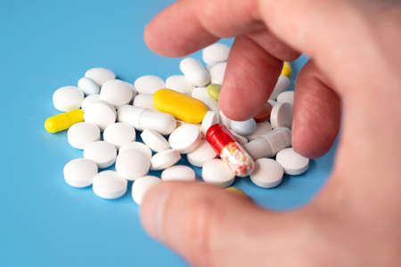 Person taking pills, drugs or pills addiction, concept pictureの写真素材