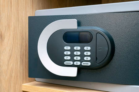 Close-up of code lock on opened iron safe door at hotel roomの写真素材