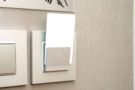 White plastic keycard, blank electronic key insert into box in hotel, space for textの写真素材