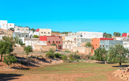 Traditional small Moroccan village with colorful houses in desertの写真素材