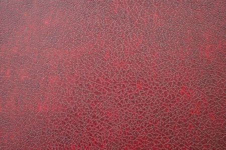 Close-up of dark red imitation leather, leatherette as texture or backgroundの写真素材