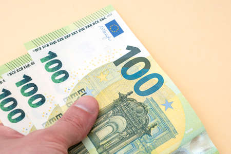 Person holding 300 euro moneyの写真素材