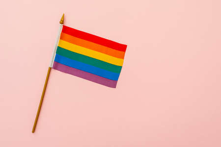 Rainbow flag as symbol of tolerance and LGBT on pink background, concept pictureの写真素材