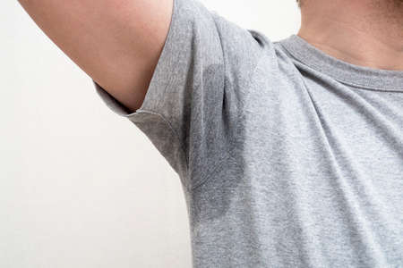 Sweaty armpit, wet underarm wet stained on gray t-shirtの写真素材
