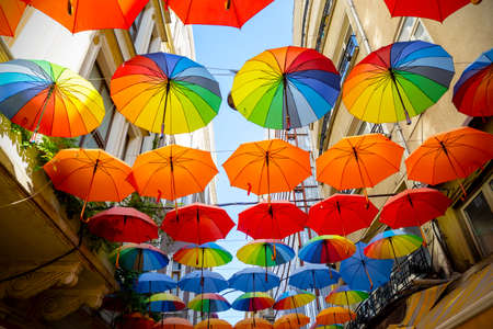 Multicolored umbrellas hanging above street in Istanbul in sunny day and blue skyの写真素材