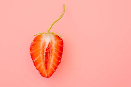 Close-up of strawberry slice with form as female vagina, creativity concept pictureの写真素材