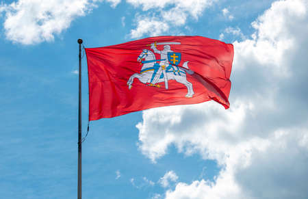 Historical state flag of Lithuania, red Vytis flag in front of blue skyの写真素材