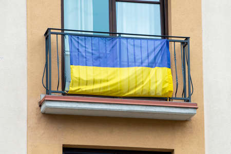 Flag of Ukraine on a balcony in a street as supporting of Ukraine in Lithuaniaの写真素材