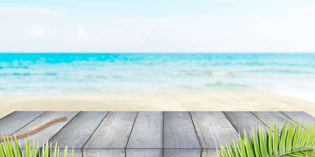 Summer holiday background with wooden deck or flooring, sea, blue sky and white sandの写真素材