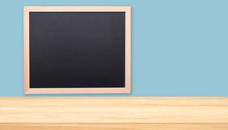 Minimal office or classroom interior with tabletop, desk and black boardの写真素材