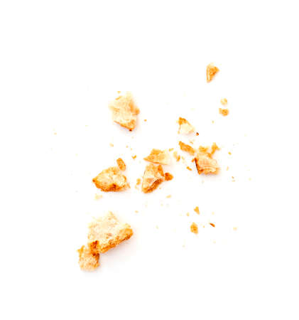 Dried crispy crumbs of white bread isolated on whiteの写真素材