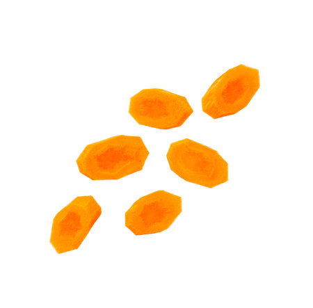Round carrot slices falling isolated on white backgroundの写真素材