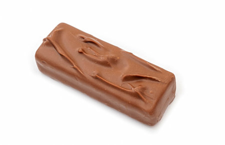 Whole long milk chocolate bar isolated on whiteの写真素材