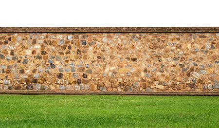 Panoramic view of the old vintage stone wall and green lawn at a garden as landscape designの写真素材
